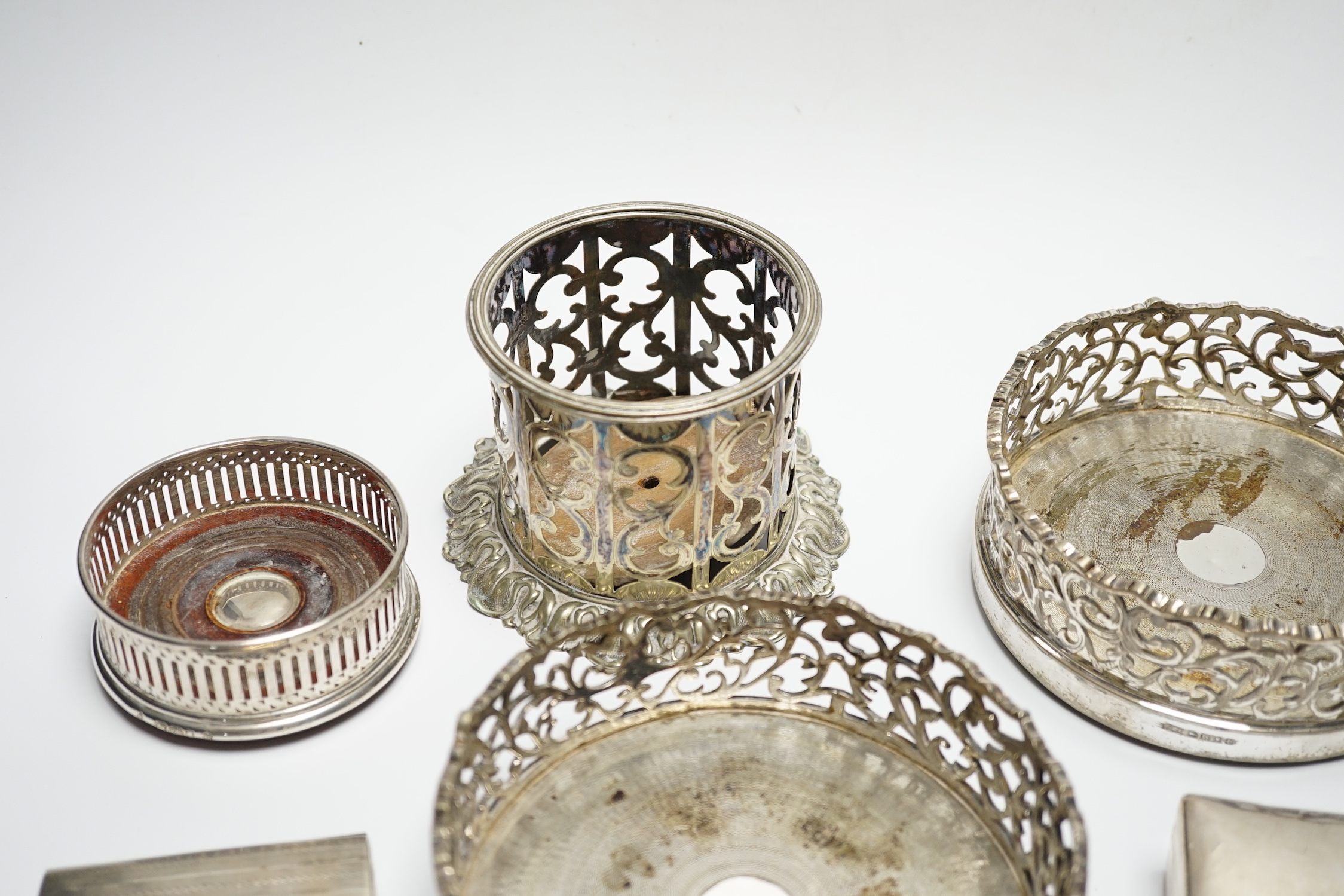 A George V silver cigarette case, 82mm, a similar silver mounted cigarette box, a modern silver mounted small wine coaster and three silver plated wine coasters including a pair.